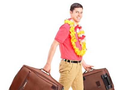 A young male walking with his luggage isolated on white backgroundの写真素材