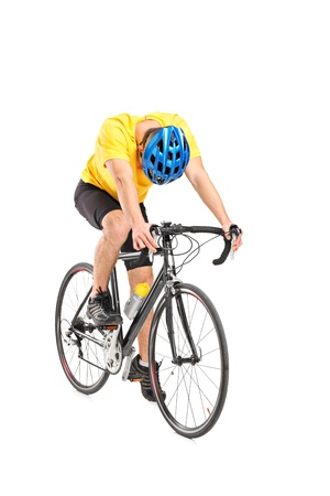 Full length portrait of a tired cyclist on a bicycle isolated against white backgroundの写真素材
