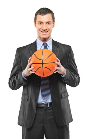 A smiling businessman holding a basketball isolated on white backgroundの写真素材