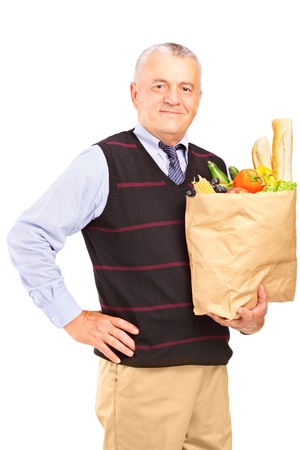 A gentleman holding a paper bag full of food isolated on white backgroundの写真素材