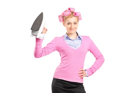 Smiling young woman holding an iron isolated on white backgroundの写真素材