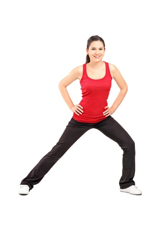 Full length portrait of a young athlete exercising isolated on white backgroundの写真素材