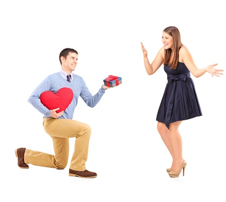 Smiling male giving flowers and excited female isolated on white backgroundの写真素材