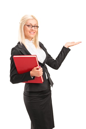 A young teacher holding a book and showing isolated on white backgroundの写真素材
