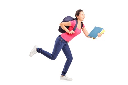 Young female student rushing forwards with book in her handの写真素材