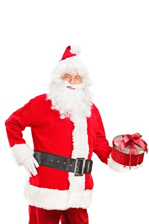 Santa Claus holding a christmas present isolated on white backgroundの写真素材