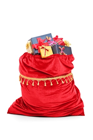 Santas bag full of Christmas presents isolated against white backgroundの写真素材