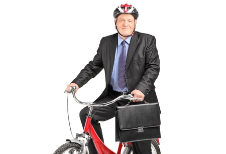 A mature businessman with briefcase on a bicycle, isolated on white backgroundの写真素材