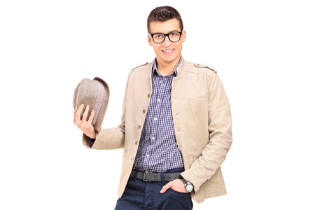 A young man holding a hat isolated on whiteの写真素材