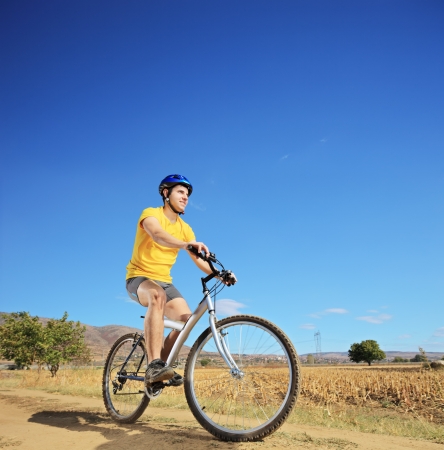 View of a biker riding a mountain bike outdoorの写真素材