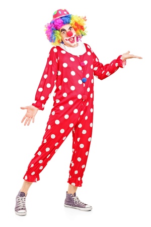 Full length portrait of a smiling happy clown gesturing isolated on white backgroundの写真素材