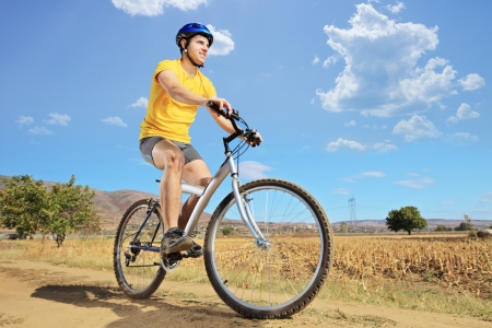 A young biker riding a mountain bike on a sunny day, Macedoniaの写真素材