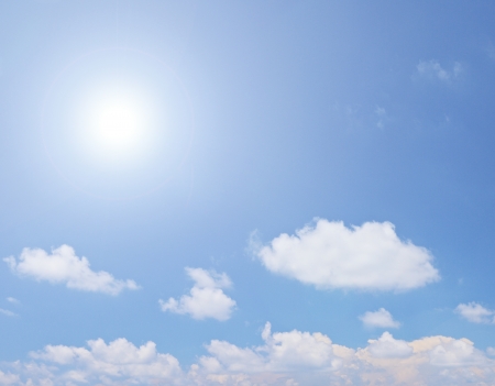 White clouds and sun over blue skyの写真素材