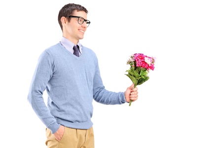 A young man holding flowers isolated on white backgroundの写真素材