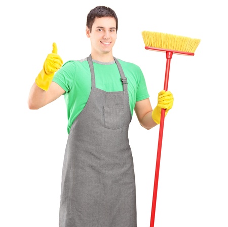 A male cleaner posing with brush and giving thumb up isolated on white backgroundの写真素材