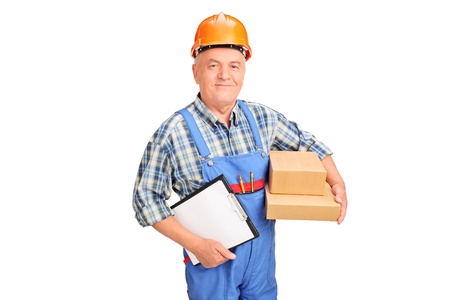 A male worker in uniform holding boxes and clipboard isolated against white background の写真素材