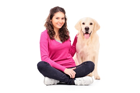 Young female posing with a dog isolated on white backgroundの写真素材