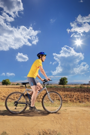 Male bicyclist riding a bike outdoorsの写真素材