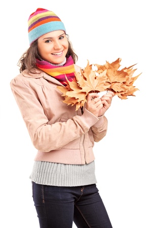 Young female holding tree leaves isolated on white backgroundの写真素材