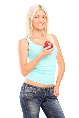 A smiling female holding a red apple isolated on white backgroundの写真素材
