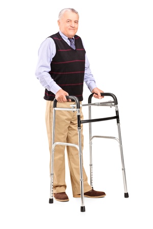 Full length portrait of a mature gentleman using a walker isolated on white backgroundの写真素材