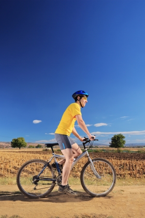 Biker in yellow shirt riding a bike on a sunny day, Macedoniaの写真素材