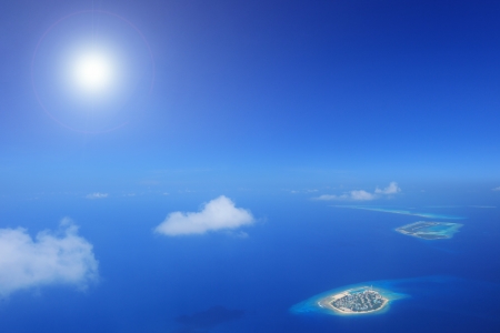 Sun and clouds over islands in Laccadives sea, Maldives, shot with a tilt and shift lensの写真素材
