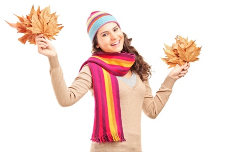 Young smiling female holding tree leaves in her hands isolated on white backgroundの写真素材