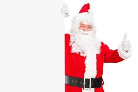 A Santa claus holding a blank billboard and giving a thumb upの写真素材