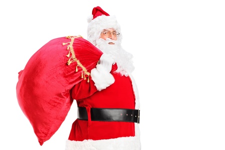 A Santa Claus walking with bag full of gifts og his back isolated on white backgroundの写真素材