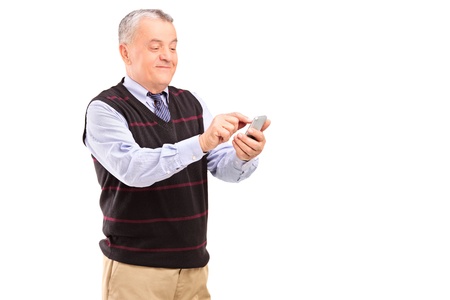 Portrait of a mature gentleman writing sms isolated on white backgroundの写真素材