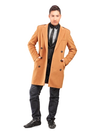 Full length portrait of a handsome smiling man wearing coat isolated on white backgroundの写真素材
