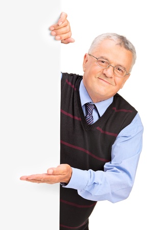 Gentleman posing behind a blank panel and gesturing isolated on white backgroundの写真素材