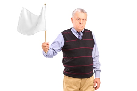 A sad senior man waving a white flag isolated on white backgroundの写真素材