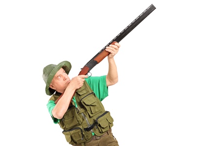 A male hunter shooting with a shotgun isolated on white background