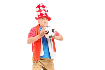 Mature male fan, with hat and flag of Holland, holding a soccer ball isolated on white backgroundの写真素材