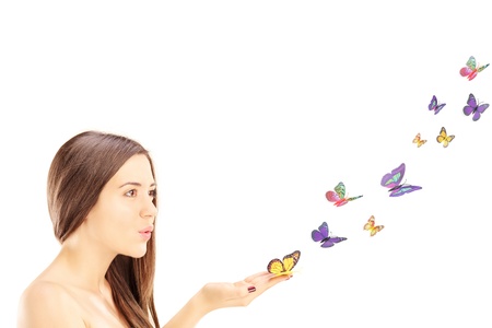 Beautiful young female with many colorful butterflies isolated on white backgroundの写真素材