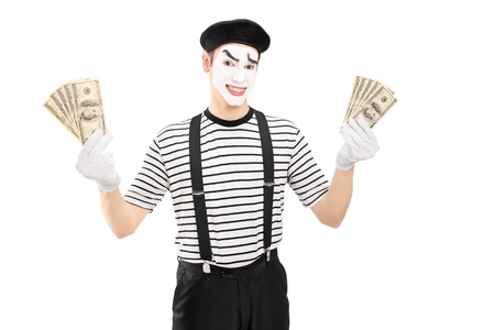 Smiling male mime artist holding US dollars and looking at camera, isolated on white backgroundの写真素材