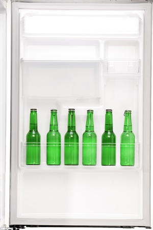 Close up of an open refrigerator full of beer bottlesの写真素材