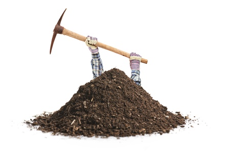 Male manual worker digging a hole isolated on white backgroundの写真素材