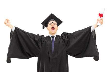 Male graduate student holding a diploma and throwing his hands in the air isolated on white backgroundの写真素材