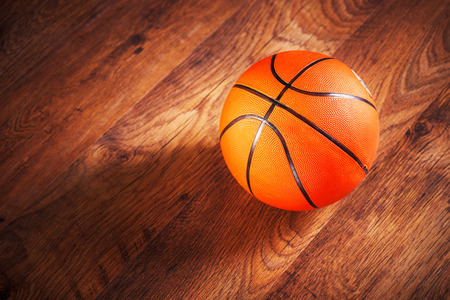 Basketball sitting on wooden floorの写真素材
