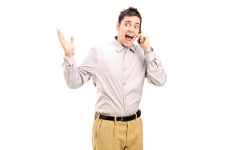 Excited man talking on the phone isolatedの写真素材