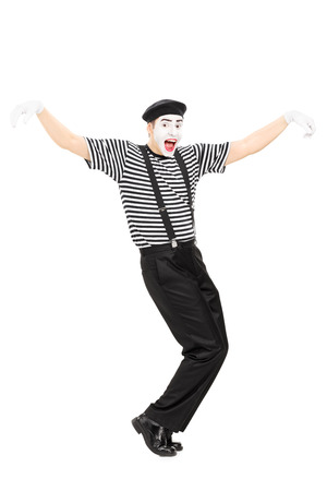 Full length portrait of a happy mime artist dancing isolated の写真素材