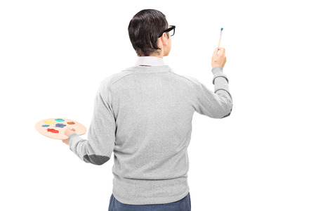 Male artist holding a paintbrush and color pallet isolated の写真素材