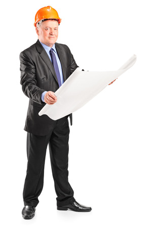 Mature architect looking at a construction plan isolated on white backgroundの写真素材