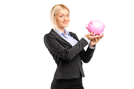 Happy businesswoman holding a piggybank isolated on white backgroundの写真素材