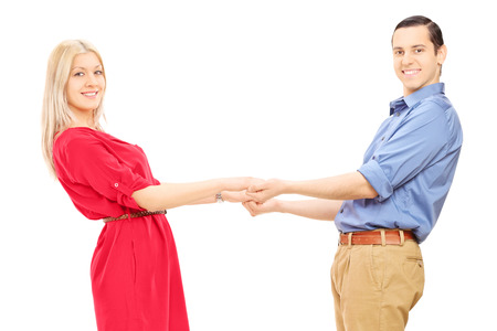 Young couple holding hands isolated on white backgroundの写真素材