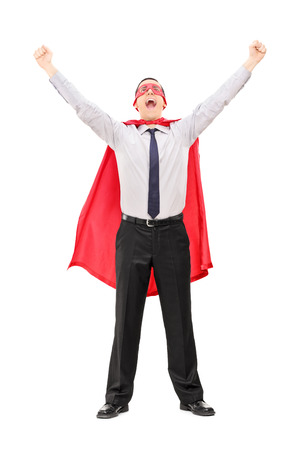 Full length portrait of a male super hero raising his hands out of joy isolated on white backgroundの写真素材