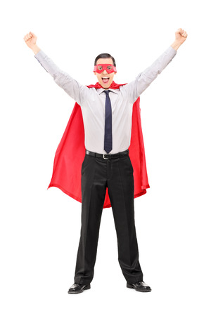 Full length portrait of an overjoyed super hero gesturing happiness isolated on white backgroundの写真素材